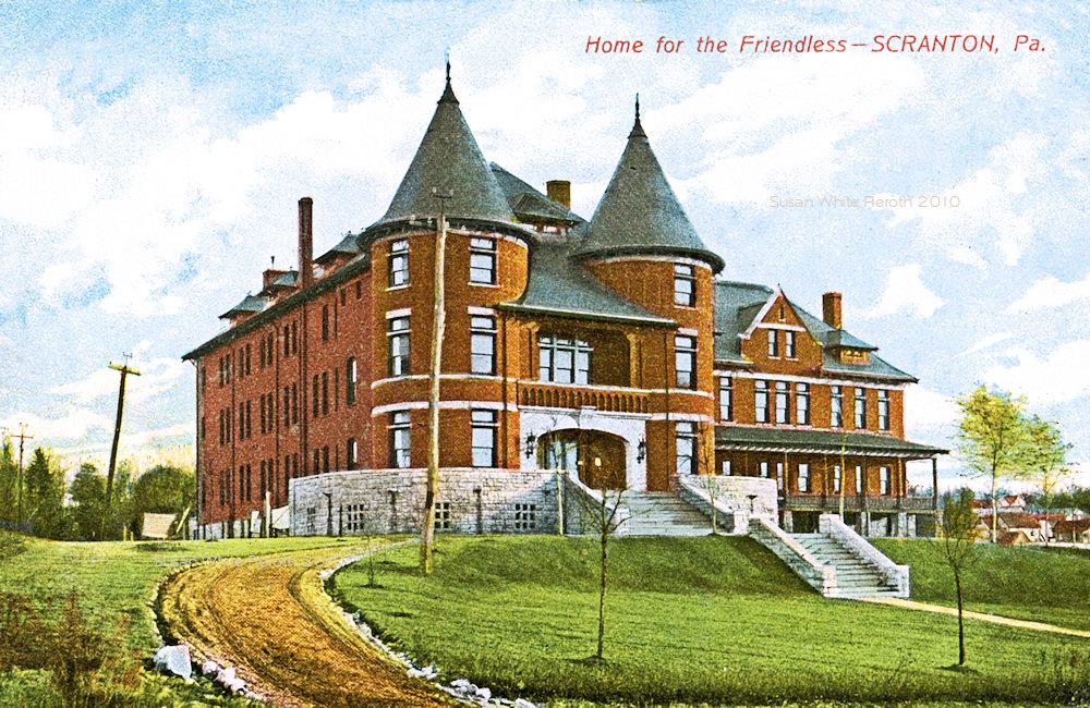The original Friendship House location - The Home for the Friendless building. A large, multi-story brick building with pointed roof.